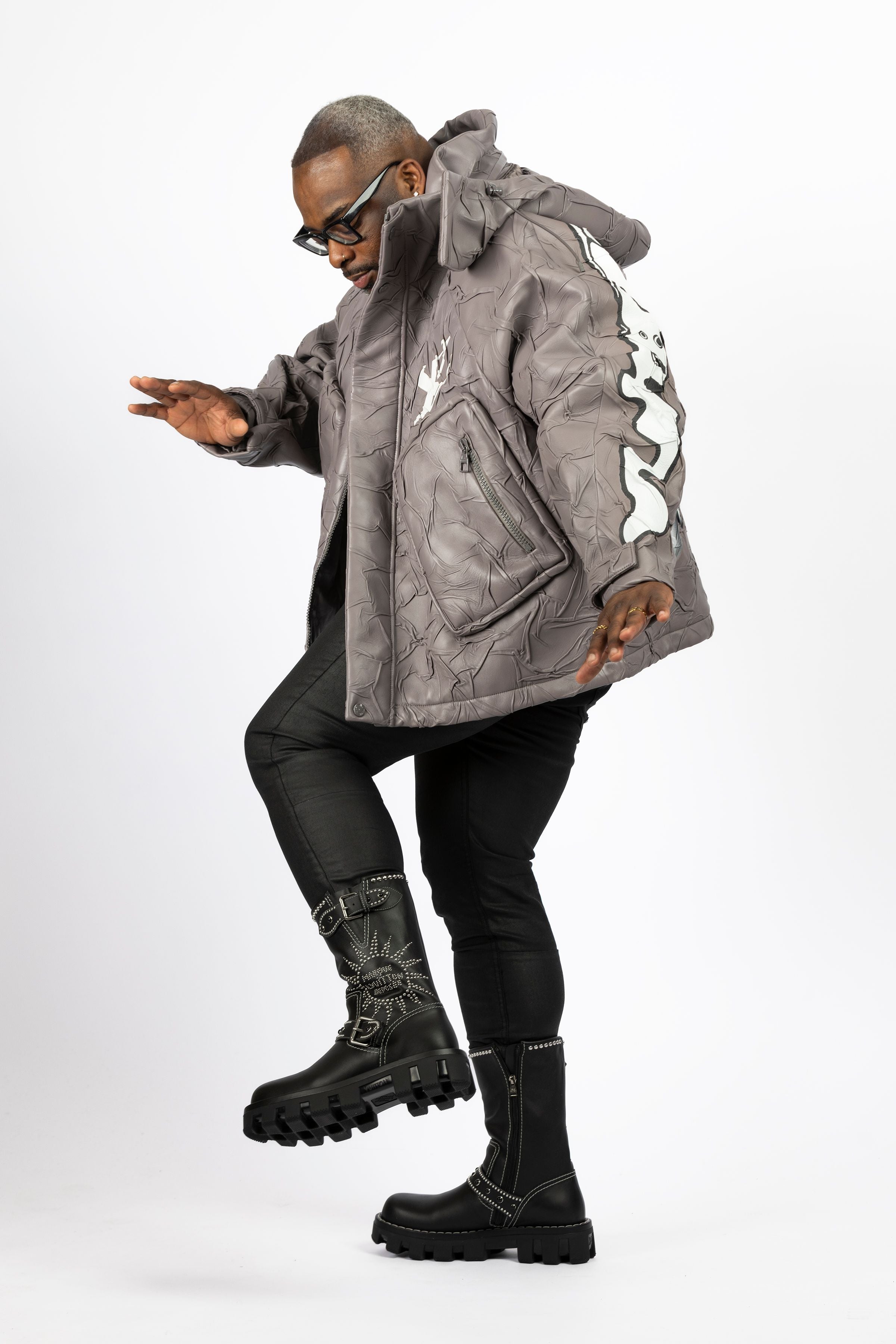 Model striking the heisman pose in the grey Louis Vuitton Compressed Leather Blouson Jacket